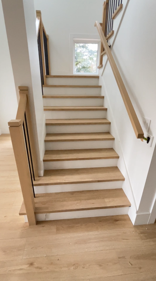 Oak staircase with wood railing and clean finish